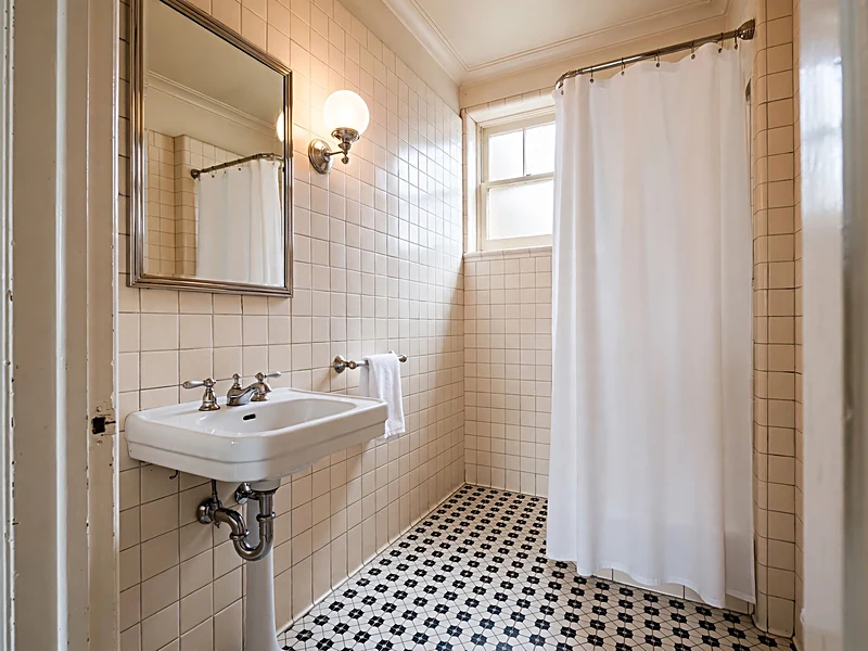 Black and white Art Deco bathroom with chrome fixtures and geometric floor tiles