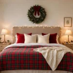 Cozy Christmas bedroom with plaid bedding, warm fairy lights, and a wreath above the bed