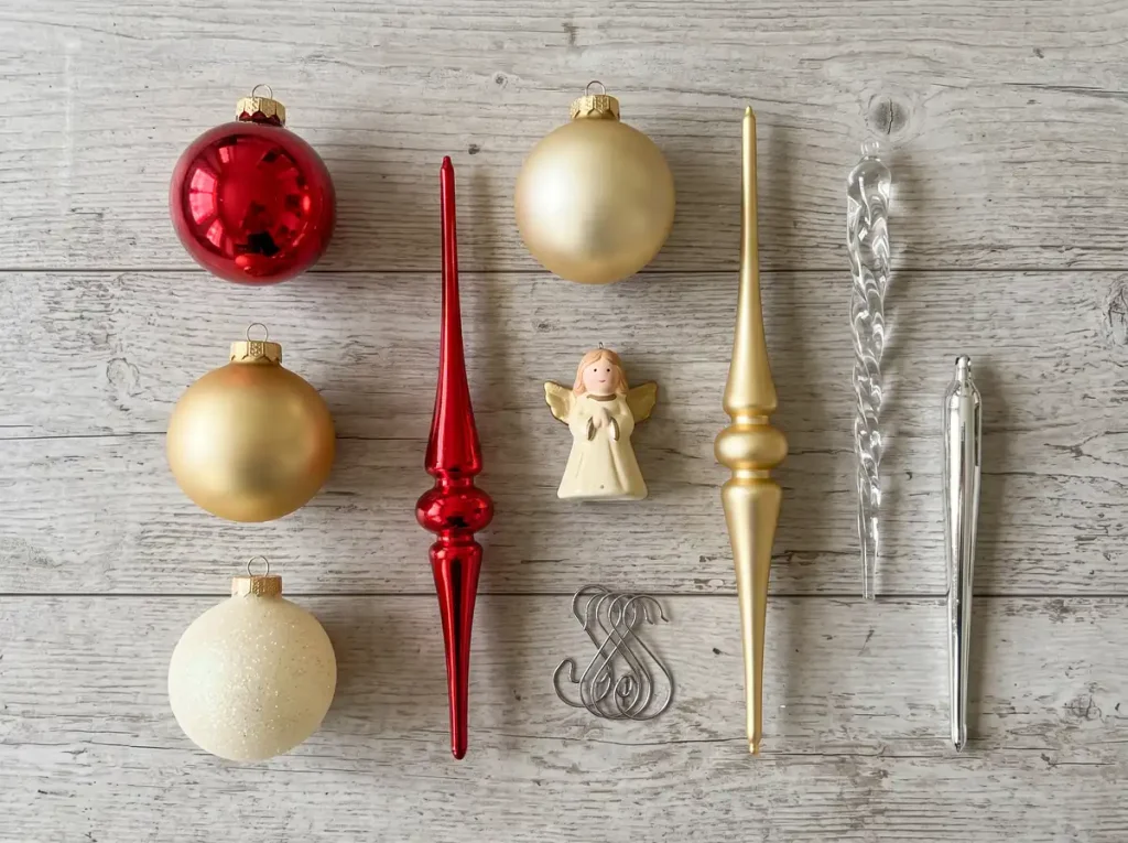 Flat lay of Christmas ornament types including globes, finials, icicles, and an angel ornament