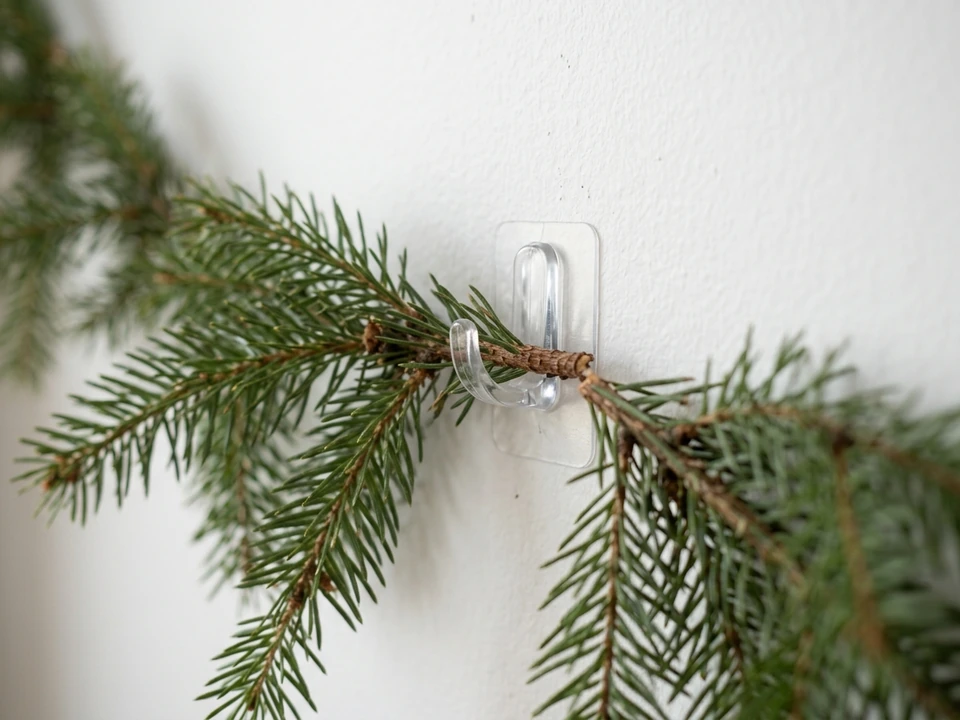 Garland held on a wall with small clear adhesive hooks